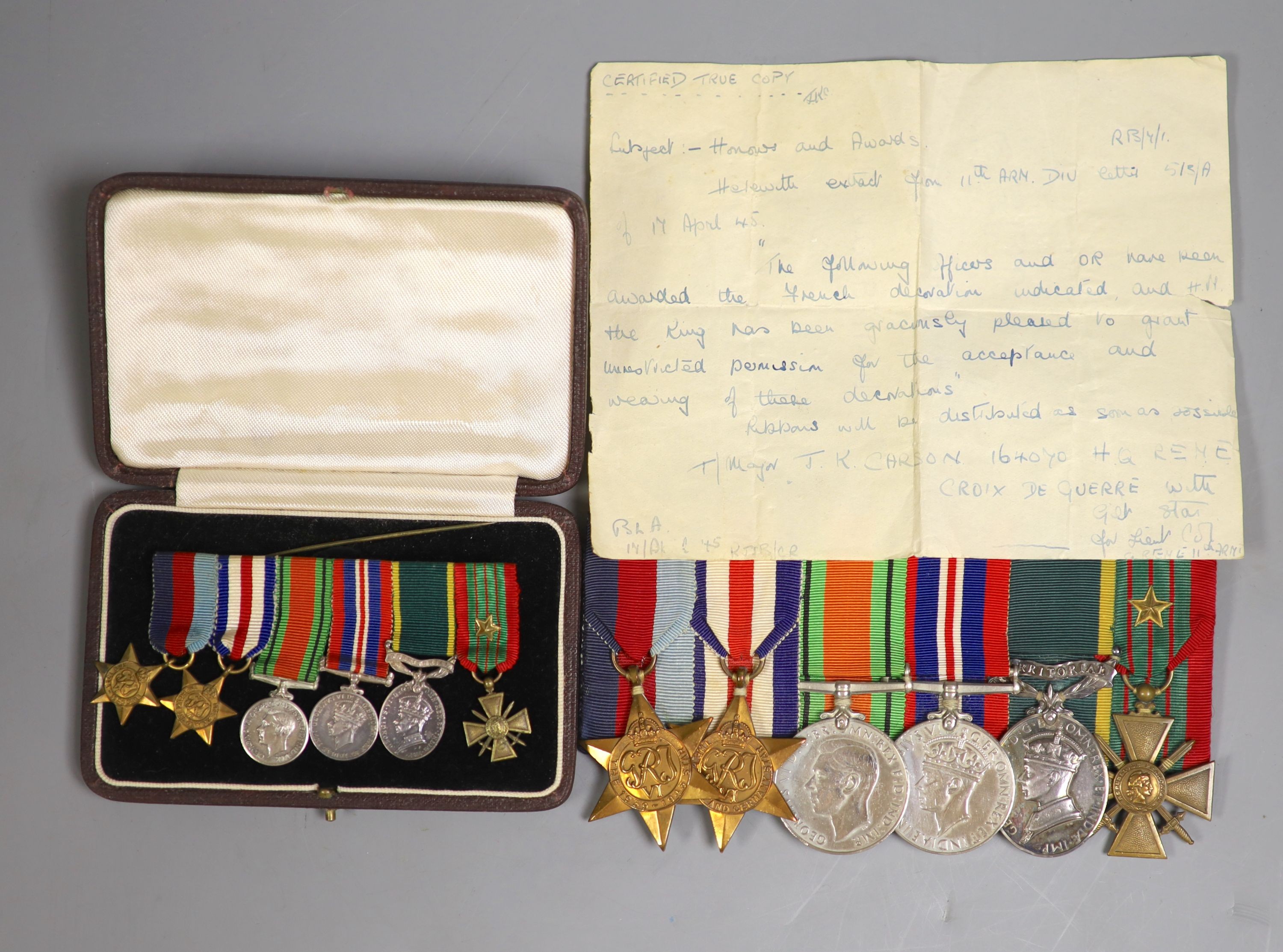 A group of WWII medals and a cased miniature group of medals, probably to War Subs. Maj J K Carson 160470, HQ REME with letter stating that the Croix de Guerre is awarded to officers of 11th Army Division